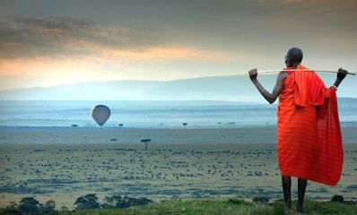 Maasai overlooking the plains of the Maasai Mara National Reserve