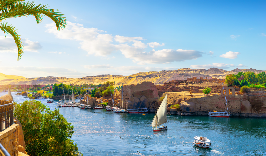 Traditional felucca sailboat gliding peacefully on the Nile River's calm waters, the perfect addition to a luxury Nile River Cruise.