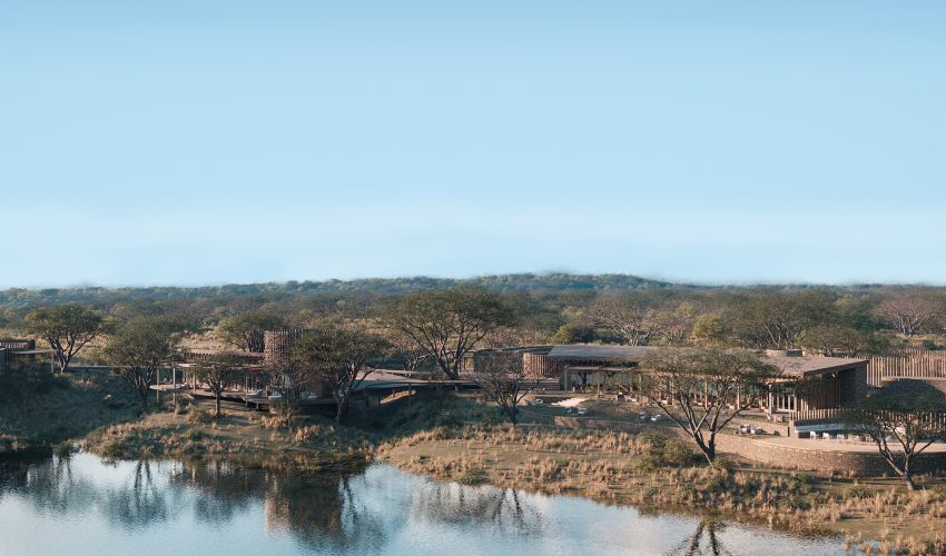 Aerial view of Sandringham Private Game Reserve’s luxury lodge overlooking a waterhole in South Africa’s Timbavati region.