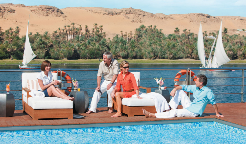 Guests on board the River Tosca during a luxury Nile River cruise enjoy a relaxing day by the pool.